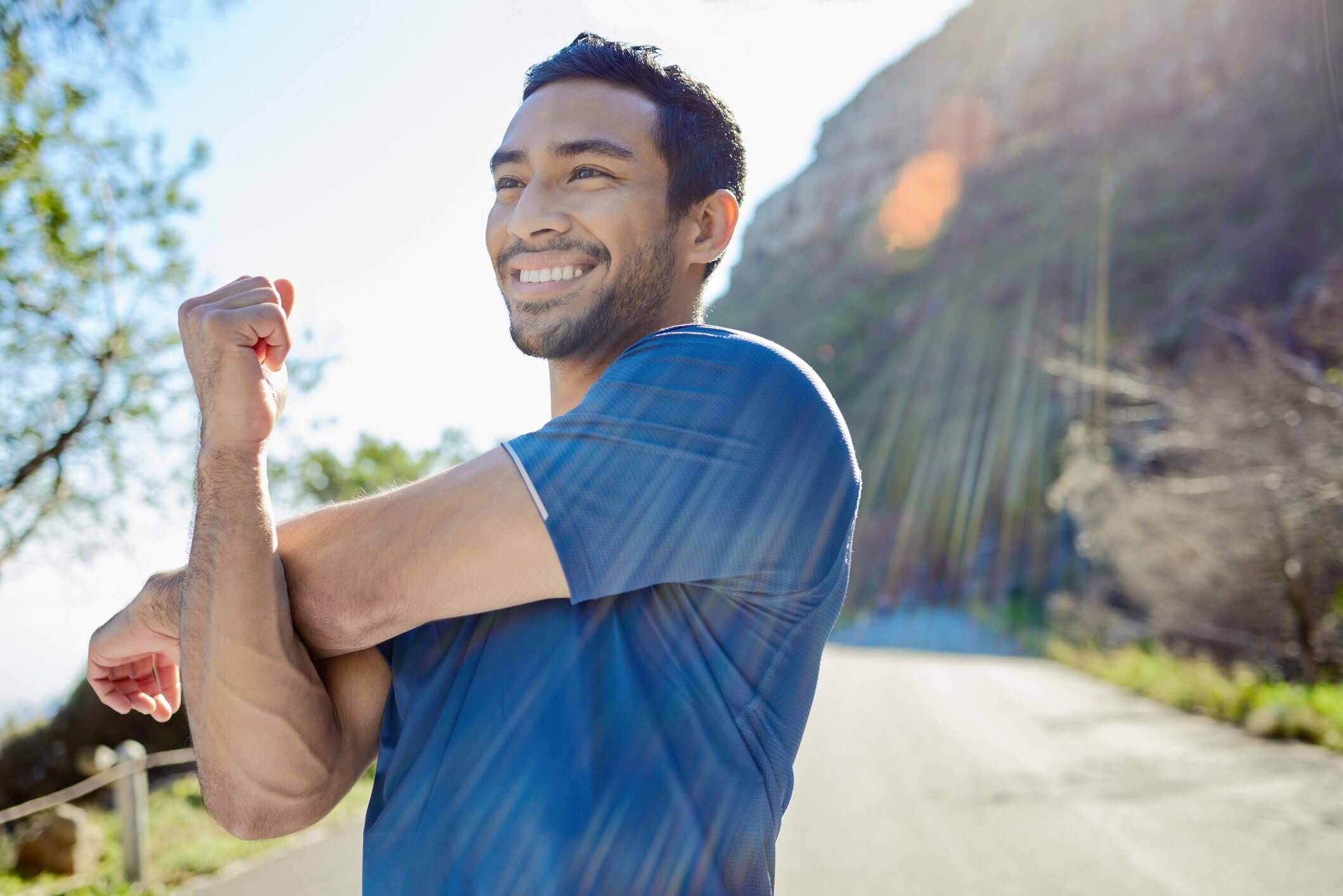 Smiling man enjoying a sunny day outdoors.