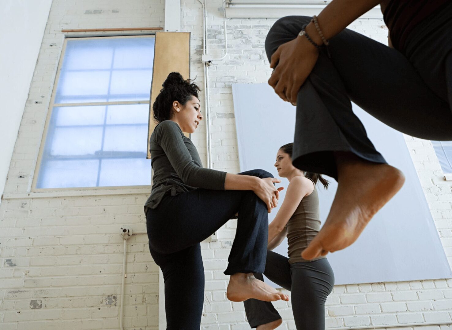People practicing yoga in a studio setting.