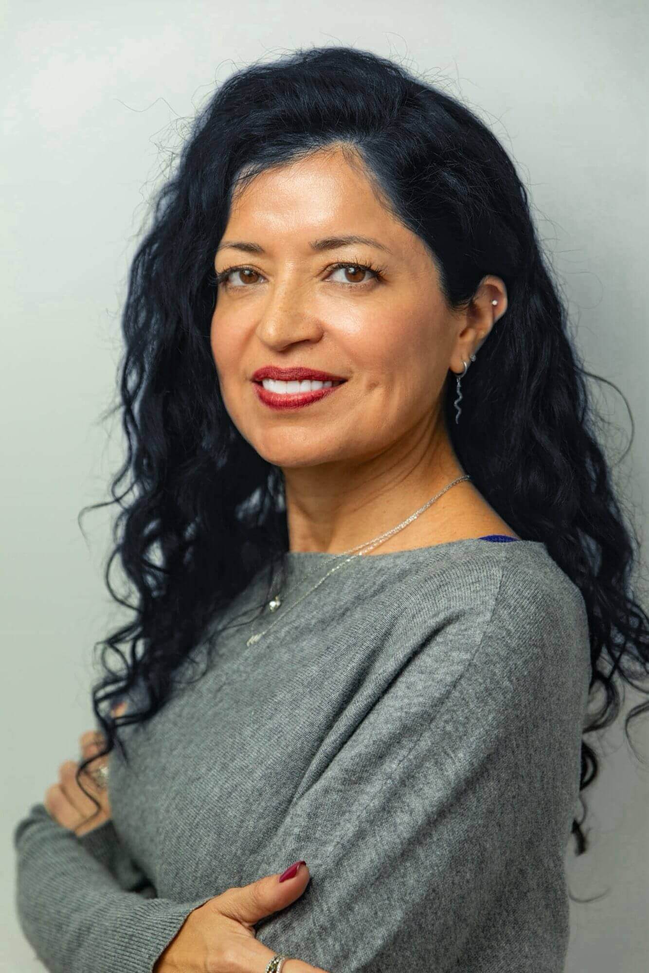 Smiling woman with long curly dark hair