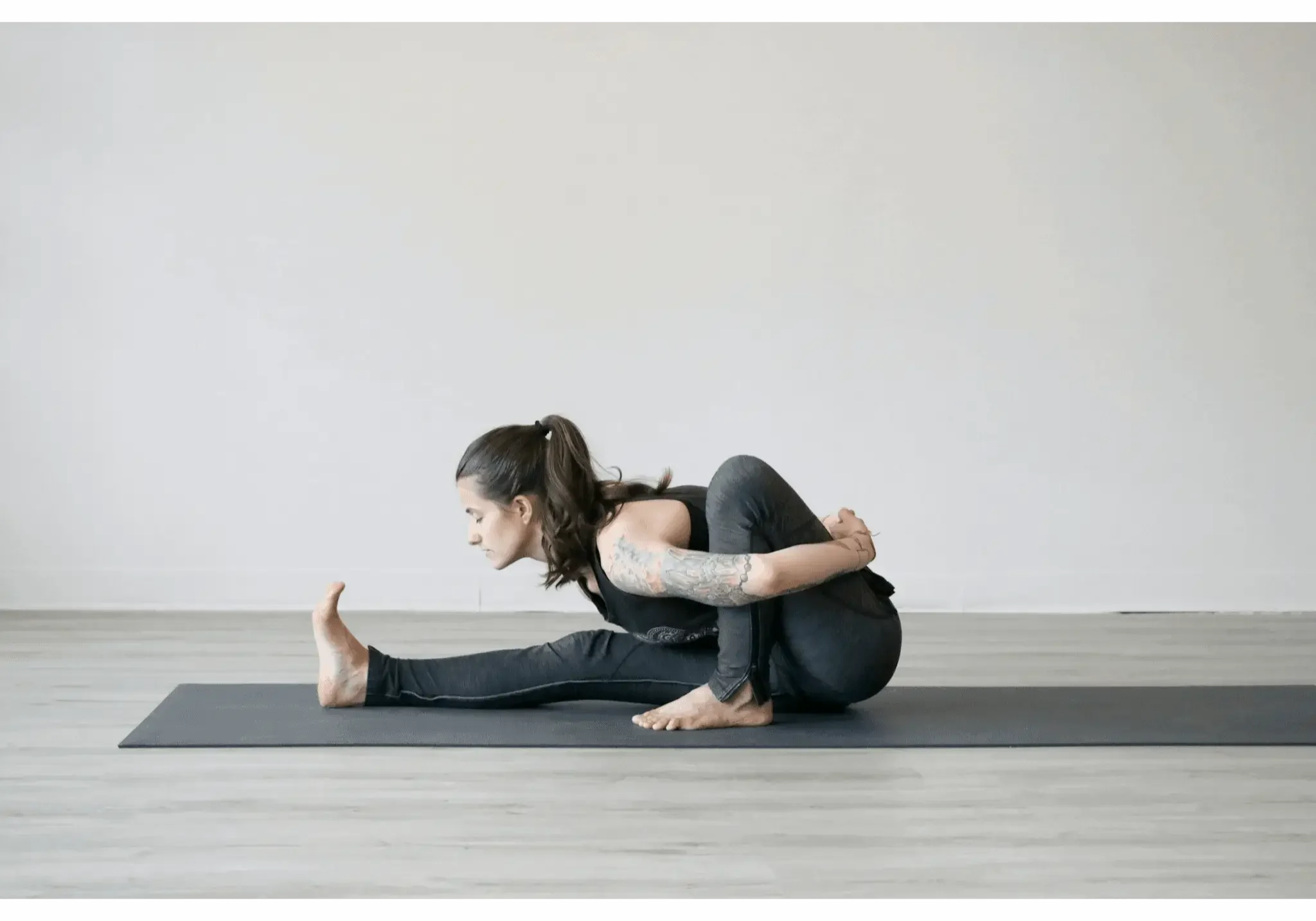 Woman practicing yoga on a mat.