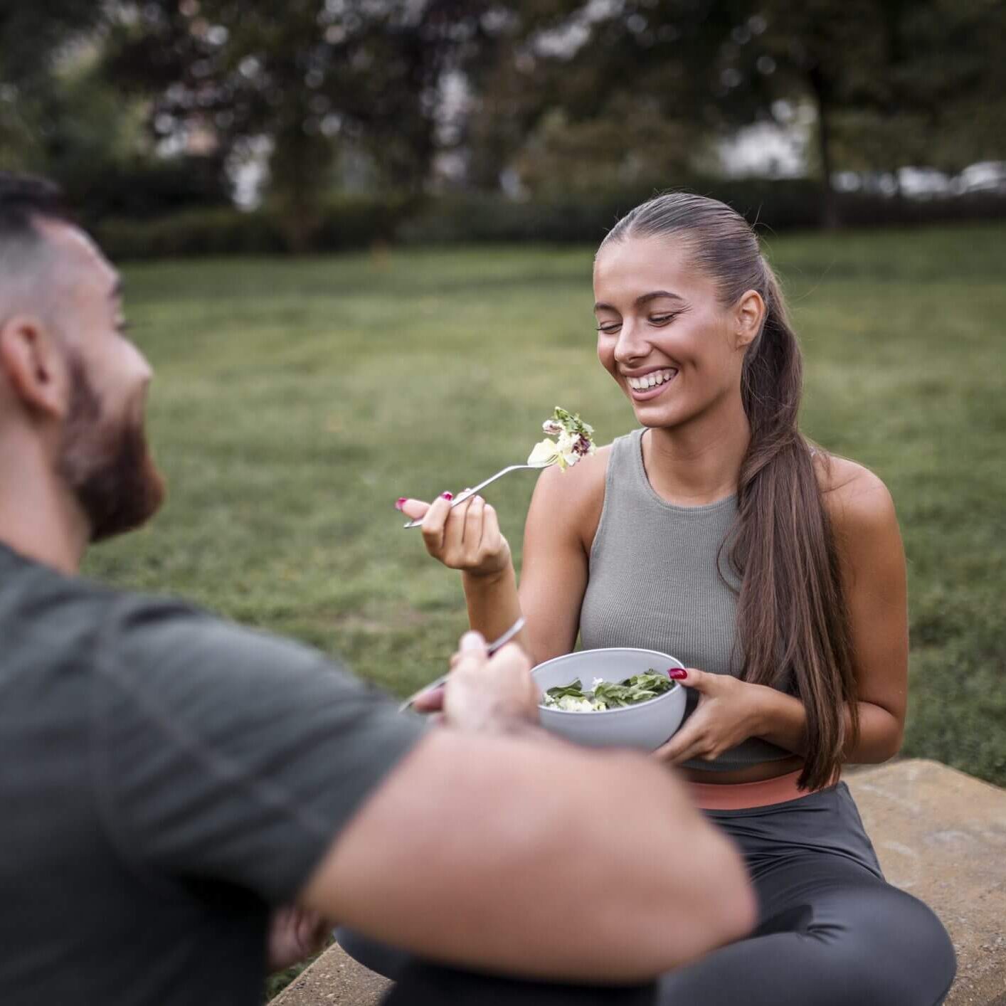 Couple enjoying a healthy meal together outdoors.