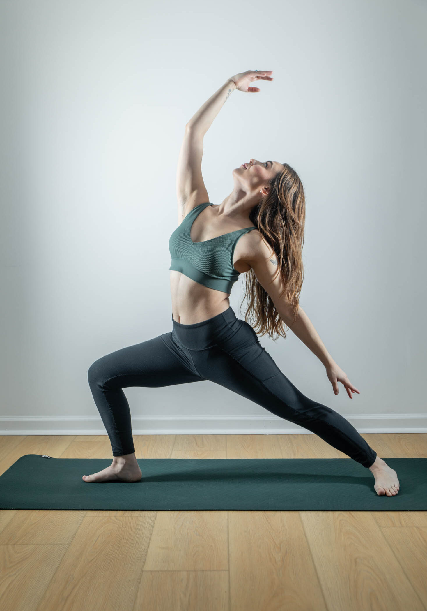 Woman practicing yoga in warrior pose.