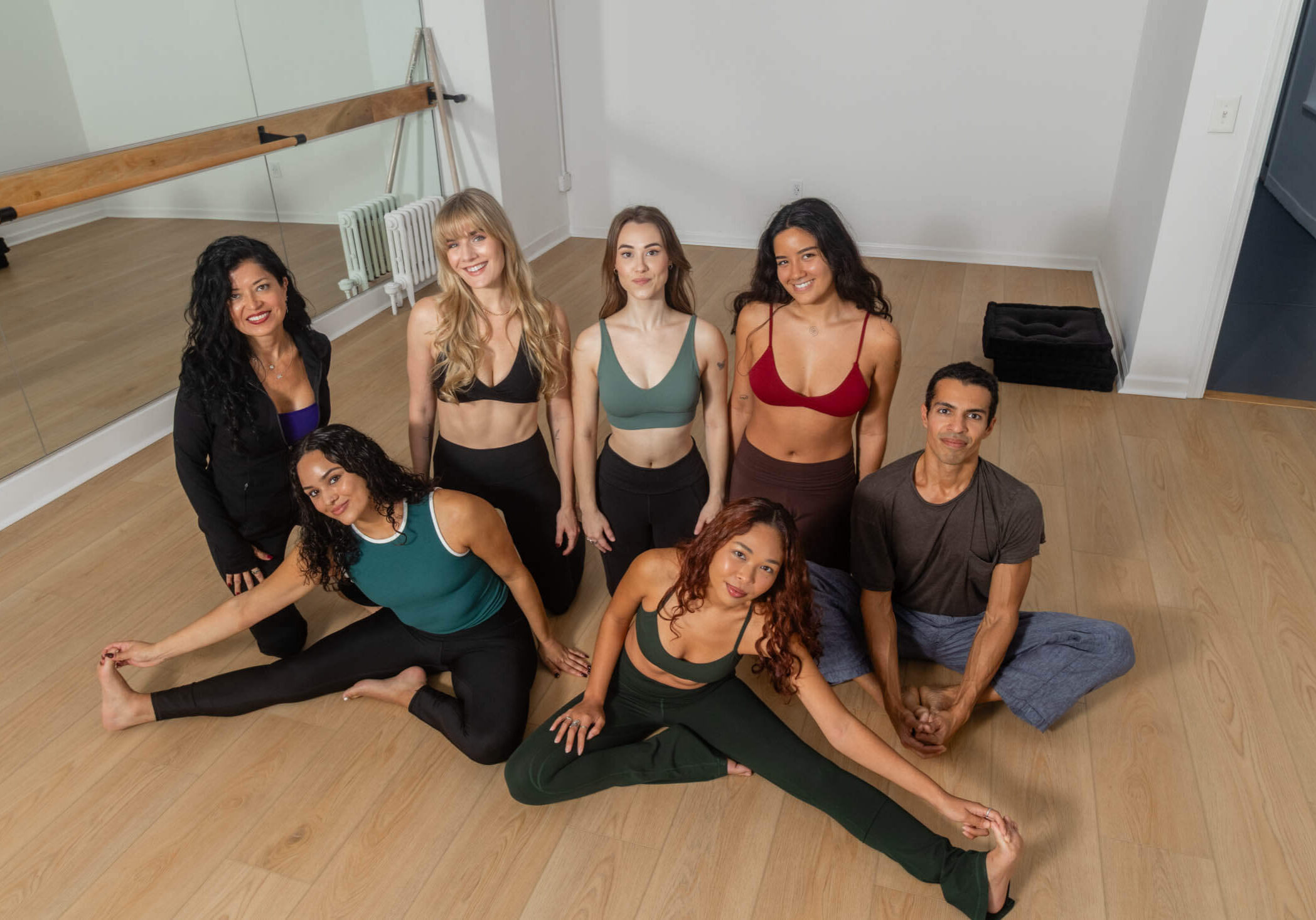 Group posing in a dance studio.